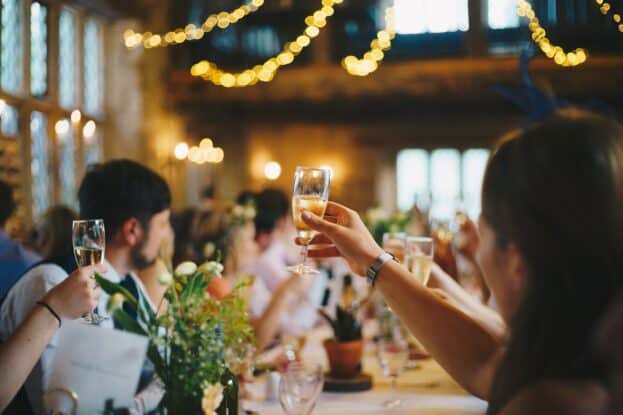 raising champagne glasses for a toast at an event